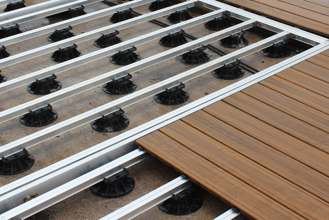 Deck installation with adjustable supports and metal framing.