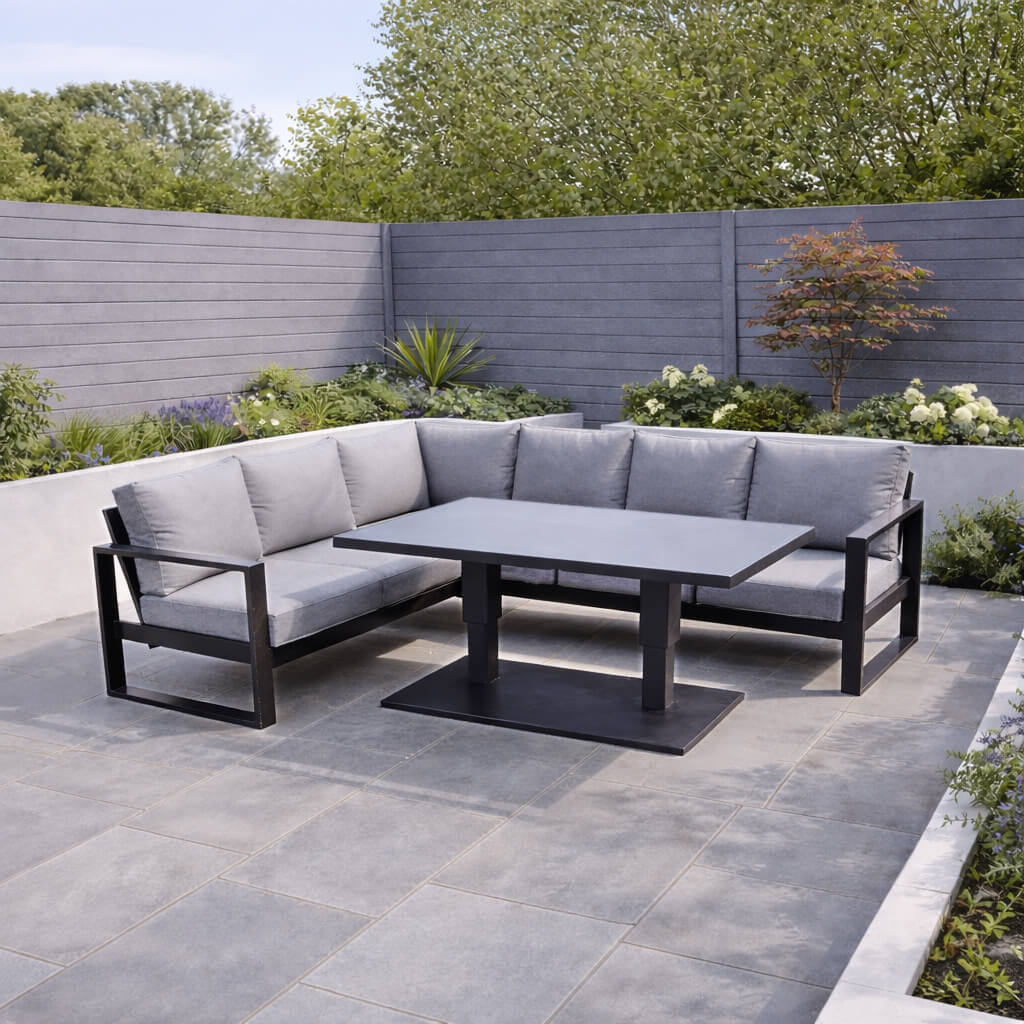 Como dark grey L-shaped outdoor furniture corner set on a stone patio.